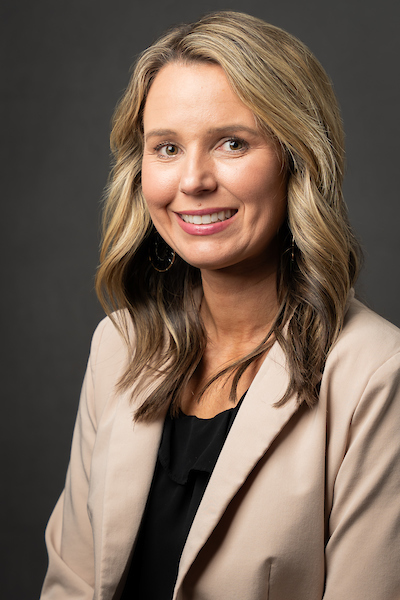 Dr. Andrea Sebastian Woman in brown suit