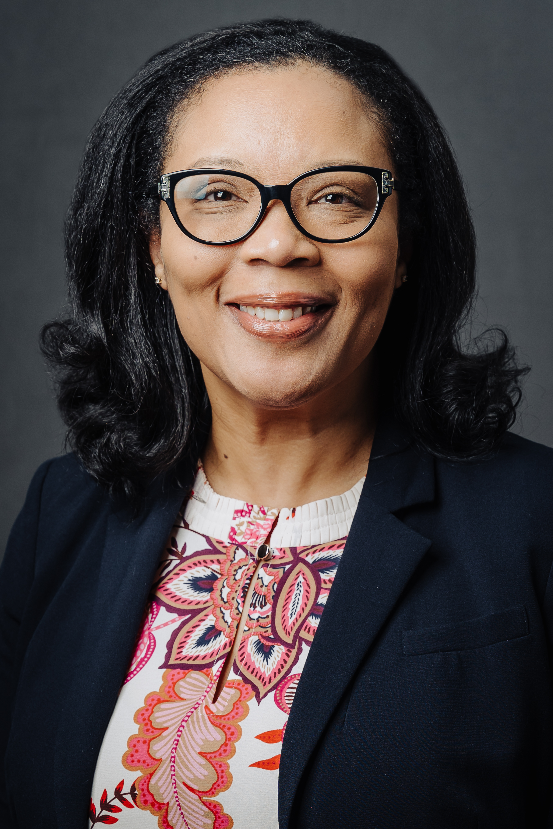 Dr. Montrese Alleyne Woman with black hair and glasses