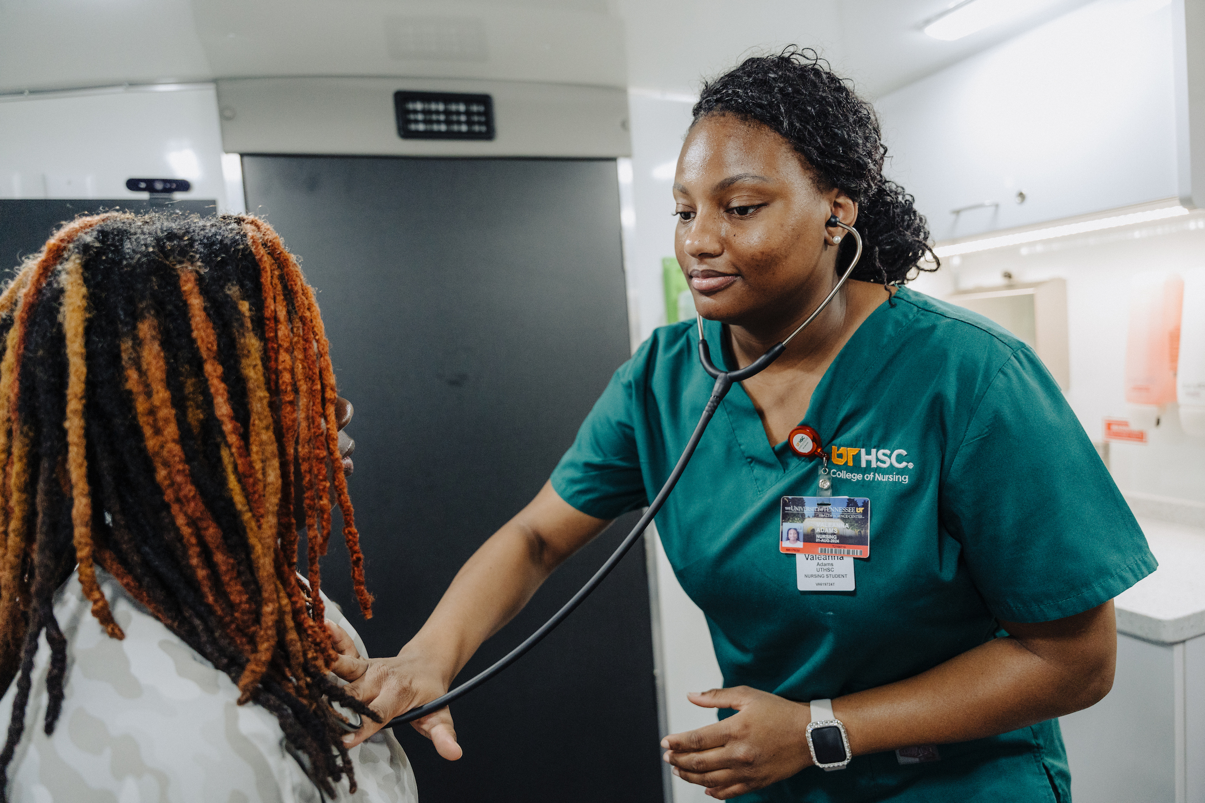 valeannaexam Nursing student examines a patient on a mobile health unit