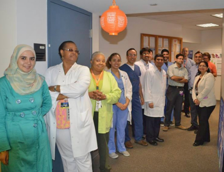 Residents and faculty standing in the hallway of the hospital
