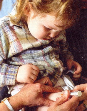 Little girl getting a shot in her belly