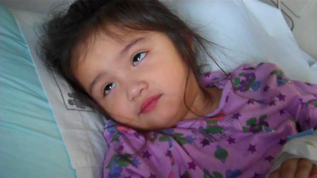 Young girl lying in a bed