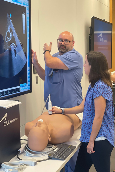 instructor looking at ultrasound