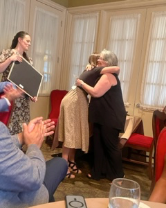 Resident and faculty hugging at the 2023 graduation