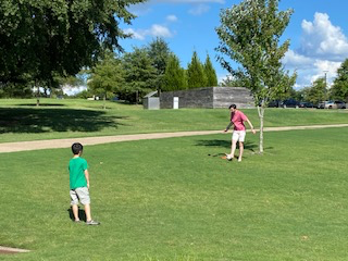 Resident and child playing in a field