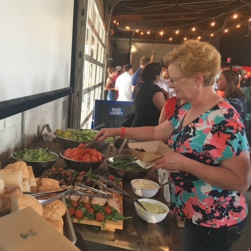 Lady making a sandwich at the party