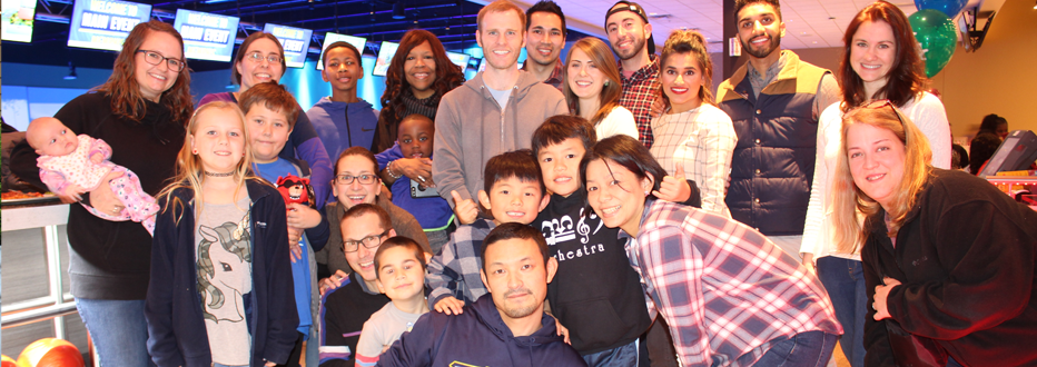 Group of residents, faculty and children at the bowling alley