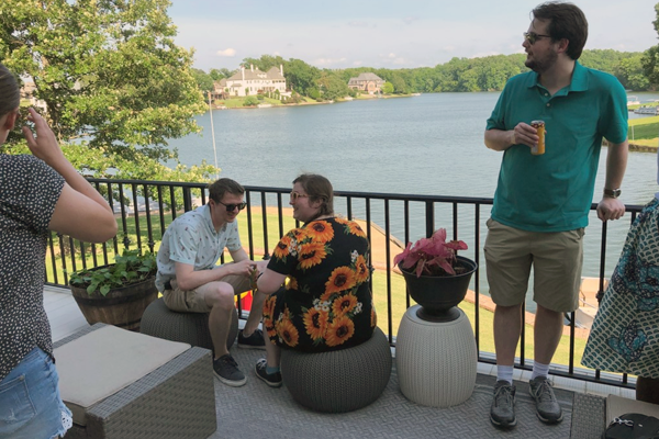 Residents at an outdoor patio by a lake