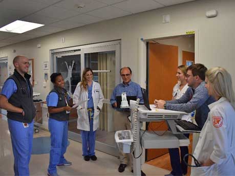 Residents talking in a hospital hallway