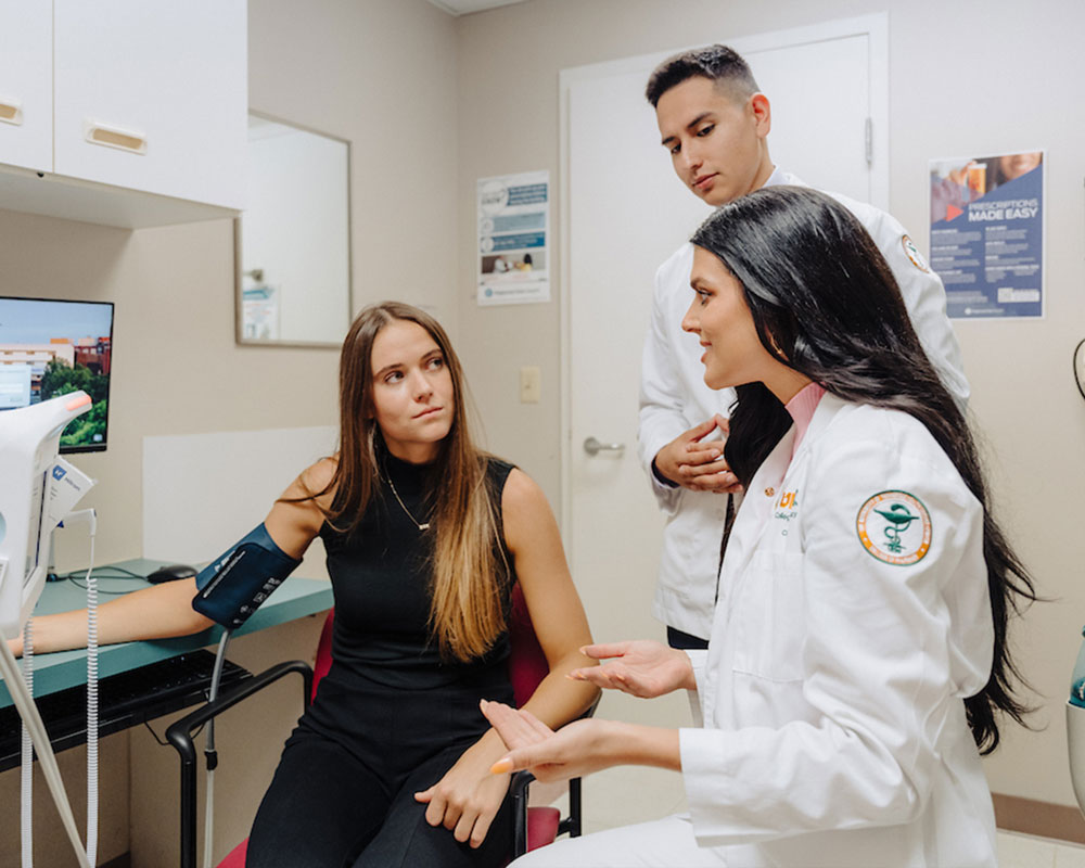 PharmD students interact with patient.