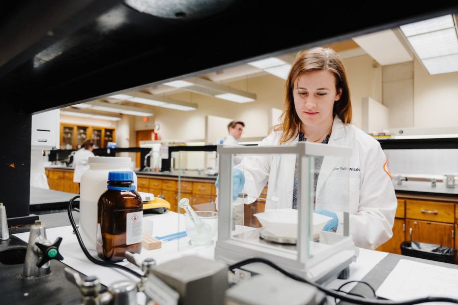 Pharmacy student recieves diploma from dean and president.