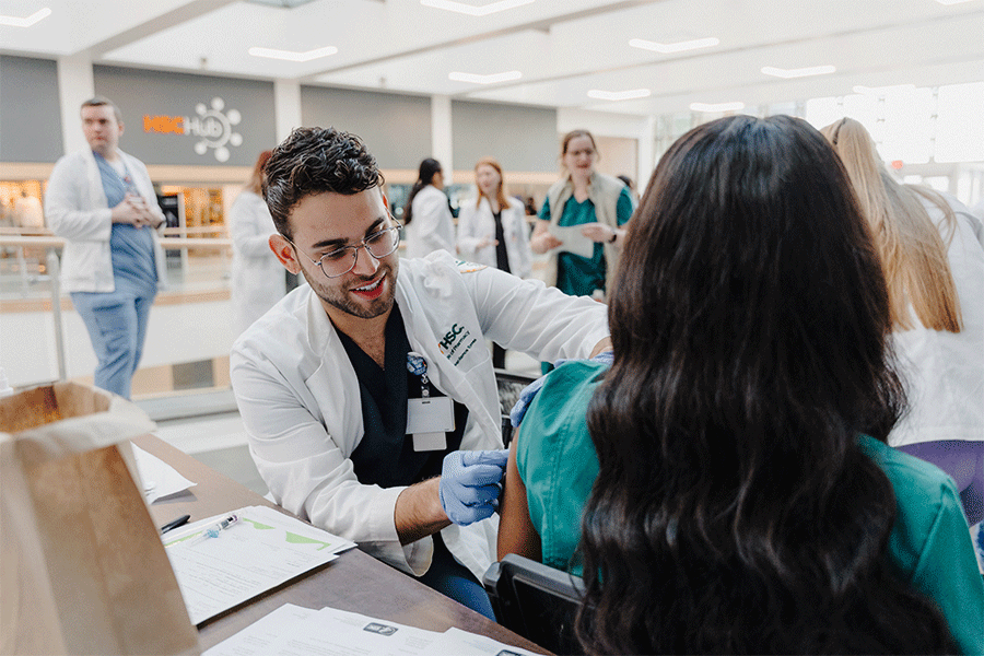 PharmD student gives vaccine.