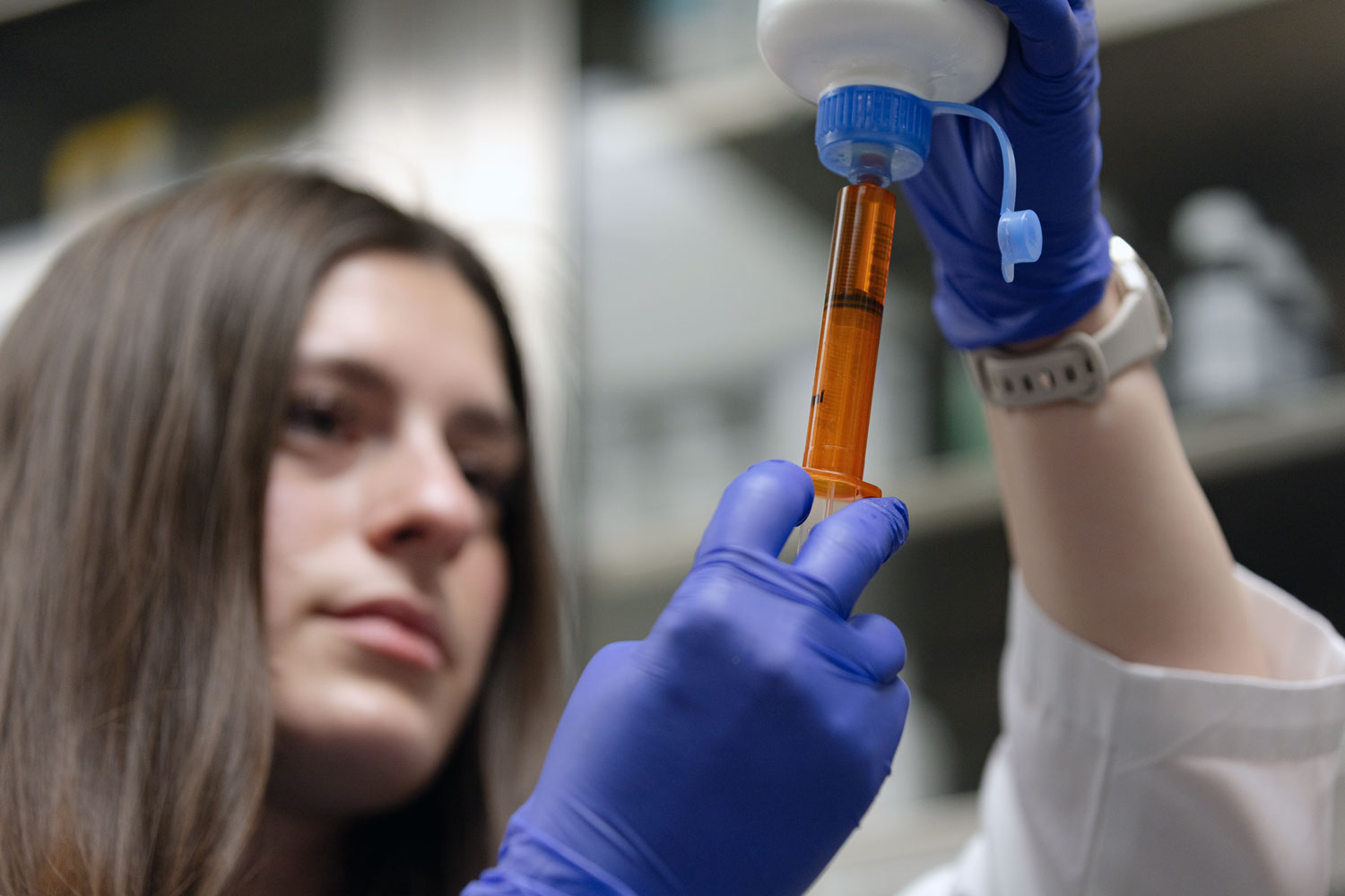 Student holding a syringe.