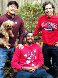 Three male residents with a dog