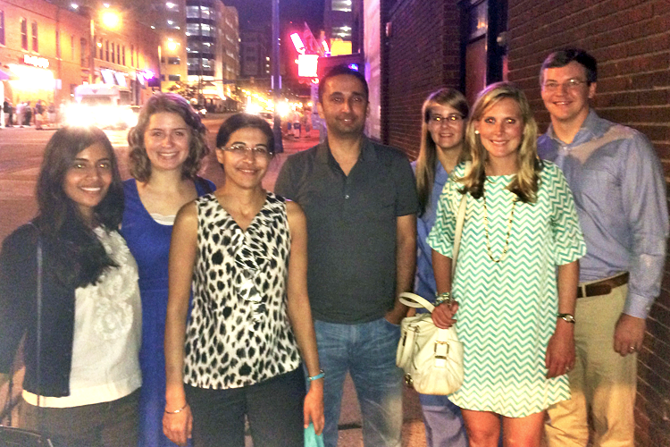 Fellows and faculty gathered outside on a street corner