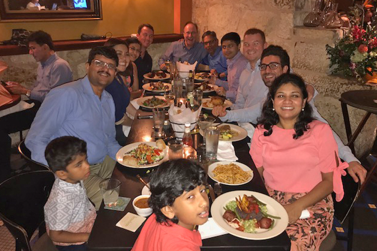 Fellows and family at a dinner table