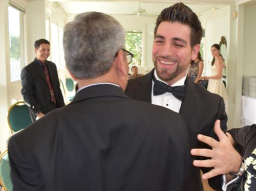 Fellow hugging a faculty member at the 2015 graduation dinner