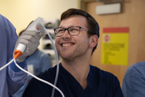 Fellow smiling in a clinical training setting