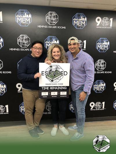 Three fellows posing in an escape room