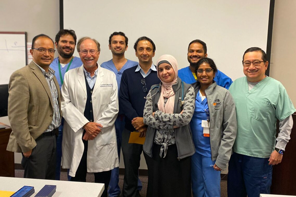 Faculty, fellows and visiting lecturers in a classroom 