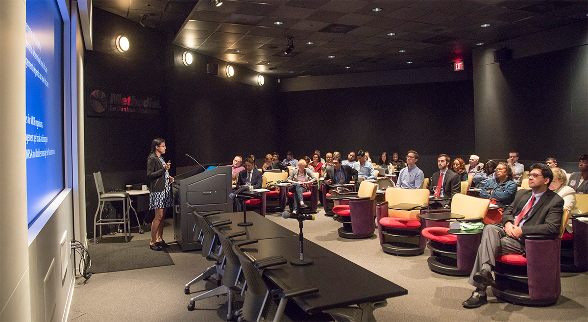 Female speaker at the podium of the conference