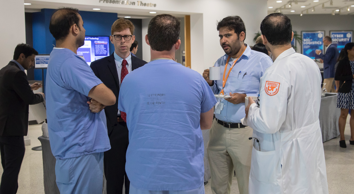 Doctors having a discussion in hallway of conference