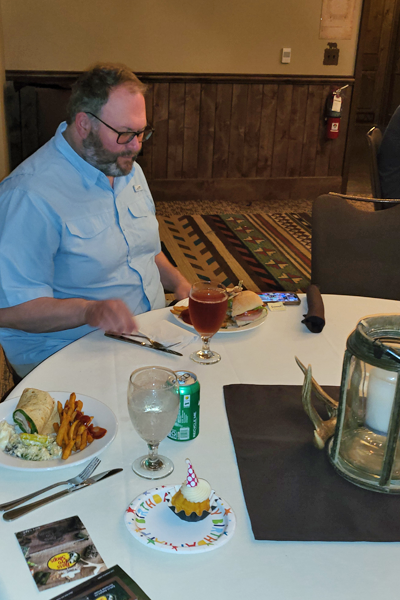 Resident eating at a dinner table at the Bass Pro Shop