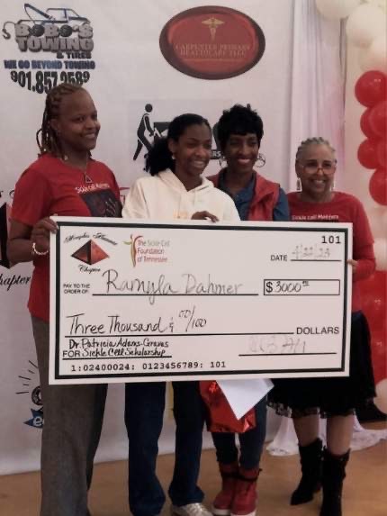 Ramyla Dahmer holding a large check being presented with 2023 Dr. Patricia Adams-Graves scholarship.