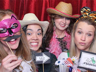 Female residents wearing props from a photo booth